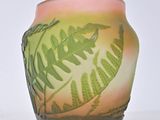 a glass vase with a fern design on it