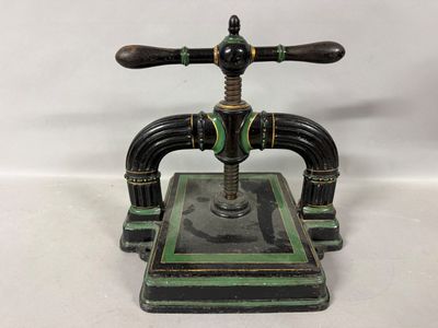 an antique cast iron faucet with green and black paint