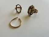 deux bagues et une bague posée sur une table, sur fond blanc