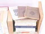 many books stacked on top of each other in a box