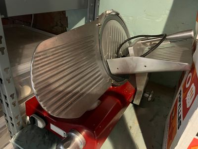 a red machine that is sitting on a shelf