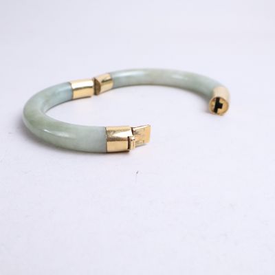 a close up of a bracelet on a white surface