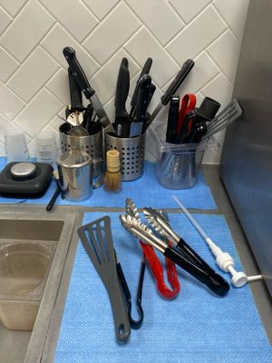 several kitchen utensils are lined up on a blue towel