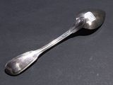 a spoon and a spoon rest on a table