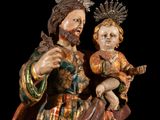an image of a statue of a man holding a child