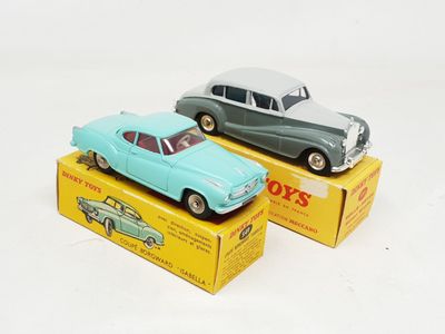 two toy cars sitting on top of a yellow box