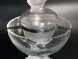 un bol en verre orné d'un oiseau, dans lequel se trouve une cuillère