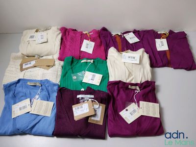 a lot of shirts that are sitting on a table