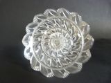 a glass plate with a design on it on a black surface