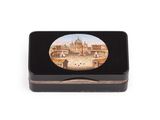 a small black box with a picture of a building on it