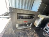 an oven that is sitting on the floor in the garage
