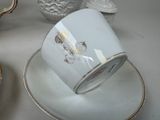 a cup and saucer sitting on a plate on a table