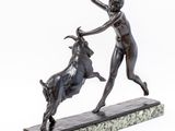 bronze statue of a woman and a bull on a marble base