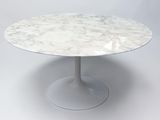 an image of a white marble table with a circular base