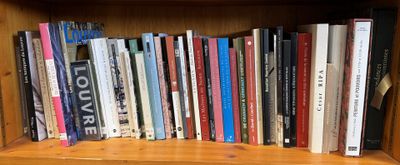 a book shelf with many books on it in a room