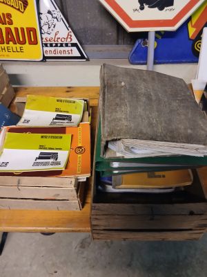 many boxes of mail sitting on a cart in a garage