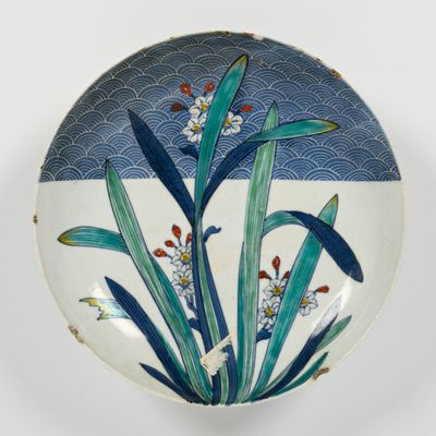 a blue and white plate with a flower design on it