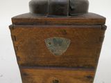 a wooden box with a metal lid on a white surface