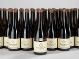 six bouteilles de vin sont alignées sur une table
