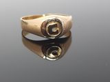 a close up of a gold ring with a diamond in the middle