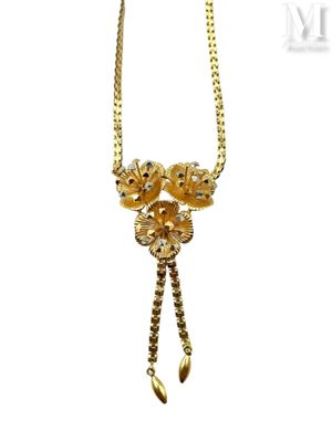 an image of a gold necklace with a flower design on it