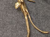 a gold figurine of a lizard on a table