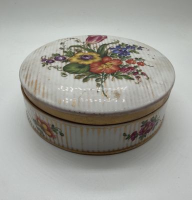 a small white box with a floral design on it