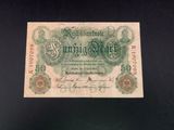 an old german banknote with a green and white design on it