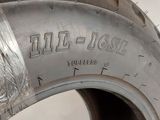 a tire that has been painted silver and has a sticker on it