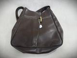 brown leather purse with zippers and a tag on it