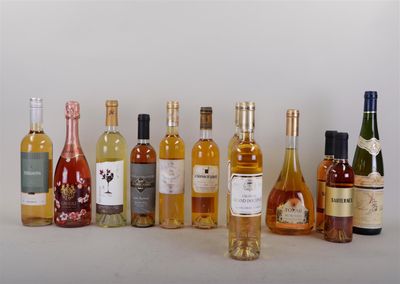 many bottles of wine that are lined up on the table