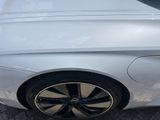 a close up of a white car with black rims