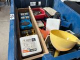 a blue dumpster with a yellow bowl and other items in it