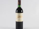 a bottle of wine sitting on top of a white table