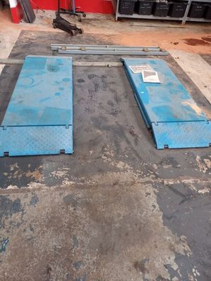 two blue steel plates sitting on top of a floor in a garage
