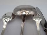 two spoons and a knife on a white table