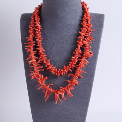 a red coral necklace on a mannequin display on a mannequin