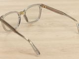 a pair of glasses sitting on a wooden table