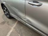 a car that has been damaged and is parked in a parking lot