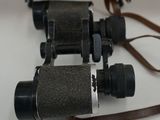 a pair of binoculars sitting on a table next to a picture frame