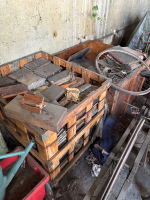 a pile of wooden crates and a bicycle in a room