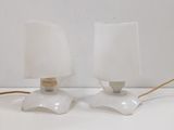 two lamps that are sitting on a white table