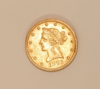 a close up of a gold coin with a woman ' s head on it