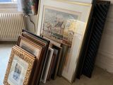 a lot of framed art on the floor in this room