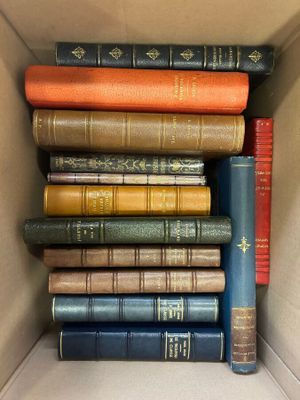 a box full of old books sitting on a table