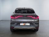 the rear end of a grey car with a red tail light