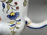a close up of a coffee cup with a flower design on it