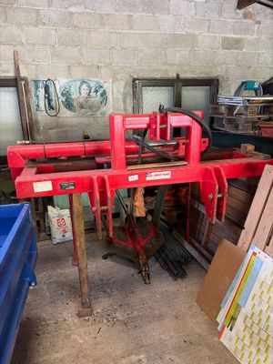 a red machine that is sitting in a garage