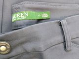 a green label on the back of a gray pants