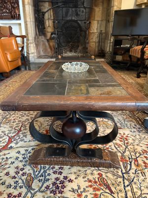 a coffee table with a bowl on it in the middle of a living room